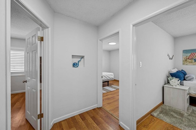 3925 Linmar Ln, Carlsbad, CA 92008 - hallway featuring a textured ceiling and wood finished floors