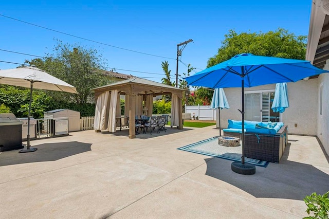 3925 Linmar Ln, Carlsbad, CA 92008 - fenced backyard featuring a gazebo, an outdoor living space with a fire pit, a patio area, a storage unit, and outdoor dining area