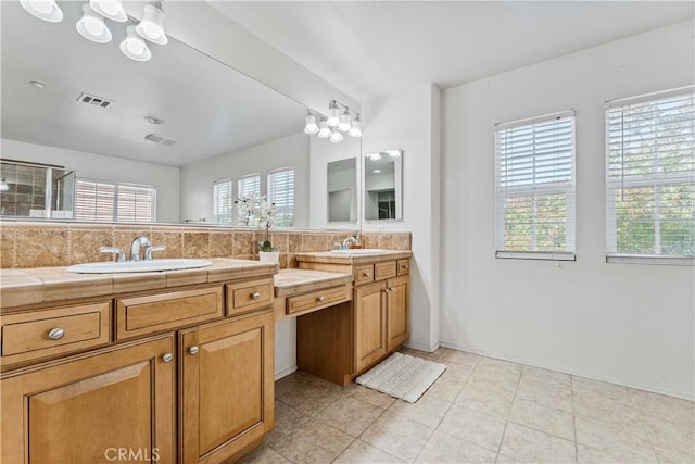 15601 N Peak Ln, Fontana, CA 92336 - bathroom with double vanity, plenty of natural light, decorative backsplash, and tile patterned flooring
