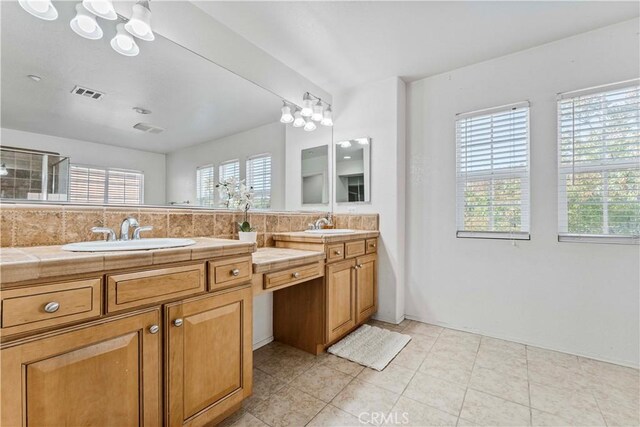 15601 N Peak Ln, Fontana, CA 92336 - full bathroom featuring double vanity, healthy amount of natural light, and backsplash