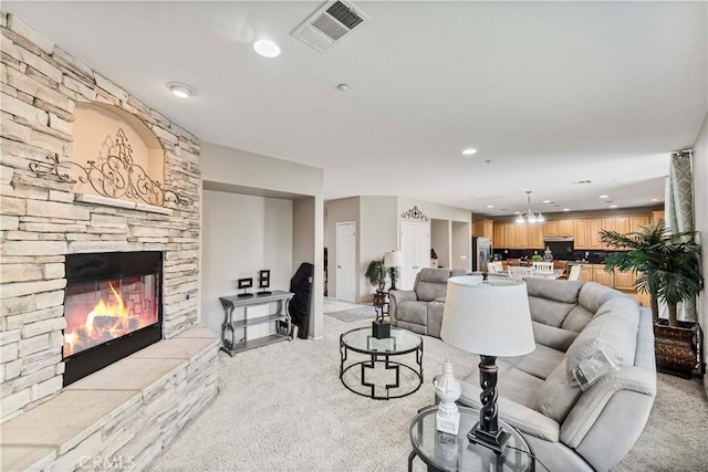 15601 N Peak Ln, Fontana, CA 92336 - living room featuring light carpet, a stone fireplace, and recessed lighting