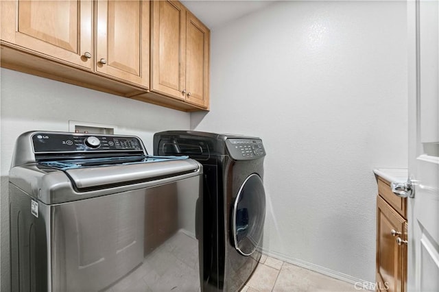 15601 N Peak Ln, Fontana, CA 92336 - laundry area with independent washer and dryer, cabinet space, baseboards, and light tile patterned floors