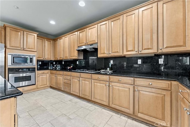 15601 N Peak Ln, Fontana, CA 92336 - kitchen featuring stainless steel appliances, under cabinet range hood, decorative backsplash, dark stone counters, and recessed lighting