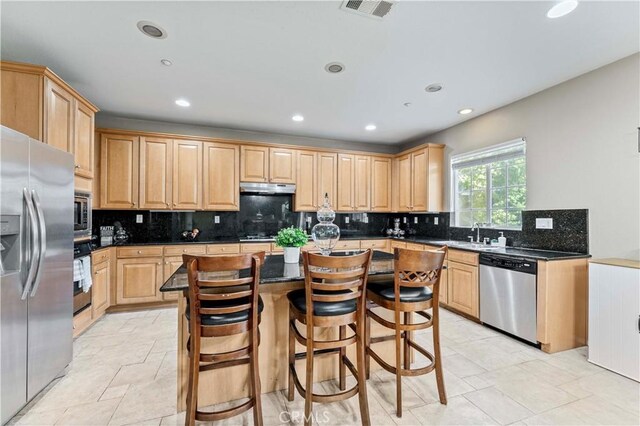 15601 N Peak Ln, Fontana, CA 92336 - kitchen with appliances with stainless steel finishes, light brown cabinetry, recessed lighting, under cabinet range hood, and tasteful backsplash