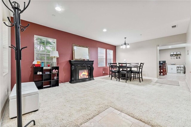 15601 N Peak Ln, Fontana, CA 92336 - dining area featuring carpet flooring, recessed lighting, a chandelier, a glass covered fireplace, and tile patterned floors