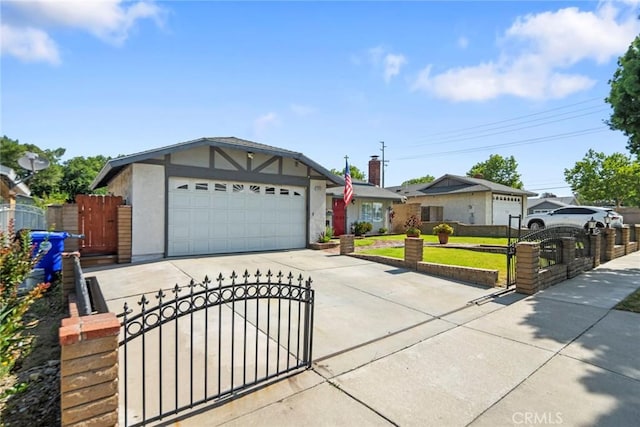 16080 San Jacinto Ave, Fontana, CA 92336 - view of front facade featuring concrete driveway, a gate, a garage, and stucco siding