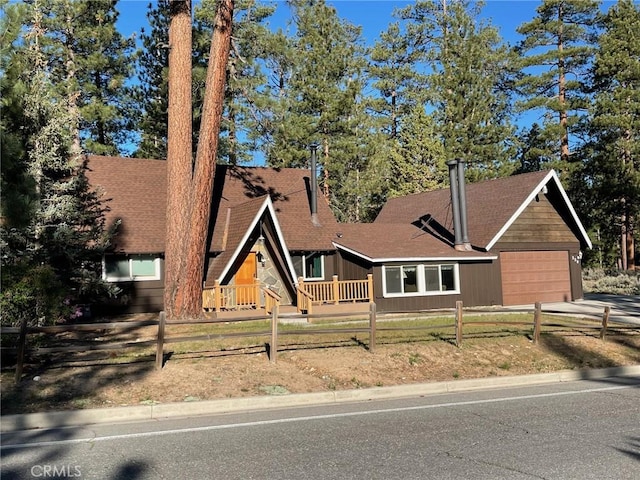 320 Starvation Flats Rd, Big Bear Lake, CA 92315 - a-frame home featuring a fenced front yard, concrete driveway, a garage, and a shingled roof
