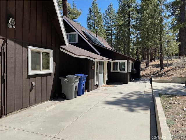 320 Starvation Flats Rd, Big Bear Lake, CA 92315 - view of side of property with board and batten siding, a patio area, and roof with shingles