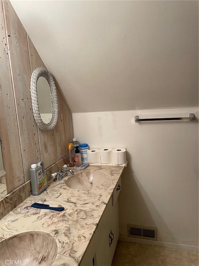 320 Starvation Flats Rd, Big Bear Lake, CA 92315 - bathroom featuring double vanity, vaulted ceiling, and wooden walls