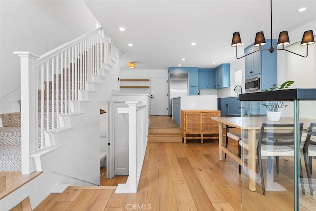 332 L St, Newport Beach, CA 92661 - kitchen featuring blue cabinets, light wood-style flooring, a sink, recessed lighting, and stainless steel microwave