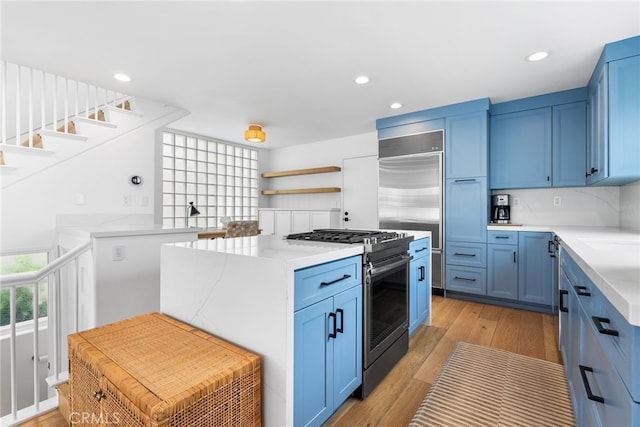 332 L St, Newport Beach, CA 92661 - kitchen with stainless steel appliances, blue cabinetry, open shelves, light countertops, and recessed lighting
