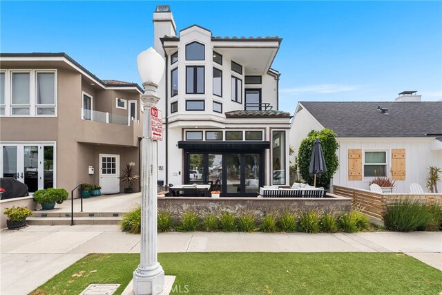332 L St, Newport Beach, CA 92661 - rear view of house featuring a chimney and stucco siding