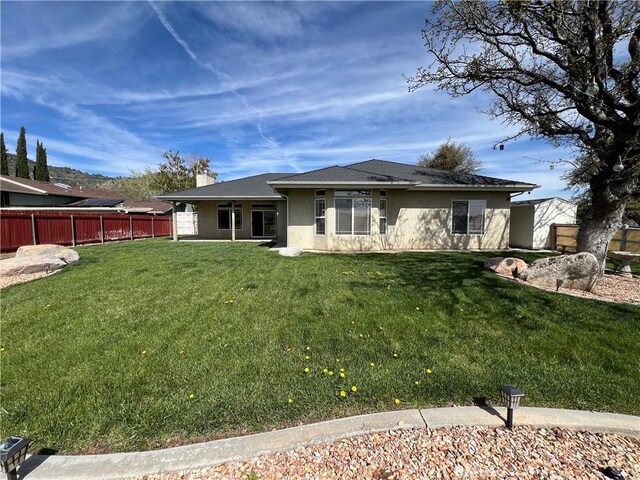 22104 Mccarthy Dr, Tehachapi, CA 93561 - back of property featuring stucco siding and a chimney