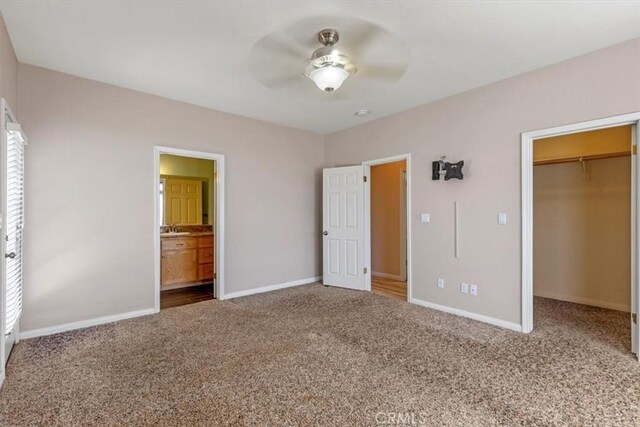 22104 Mccarthy Dr, Tehachapi, CA 93561 - unfurnished bedroom with carpet floors, a walk in closet, and baseboards
