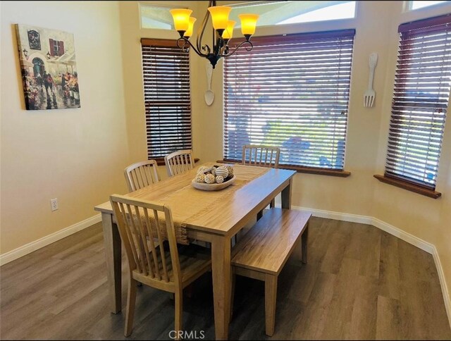 22104 Mccarthy Dr, Tehachapi, CA 93561 - dining area featuring a chandelier, baseboards, and wood finished floors