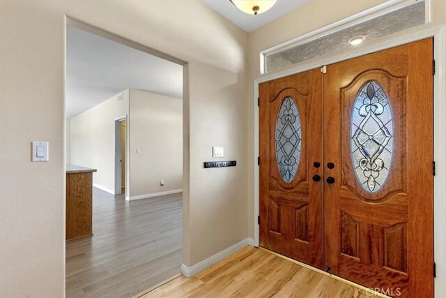 22104 Mccarthy Dr, Tehachapi, CA 93561 - entrance foyer with light wood-type flooring, baseboards, and french doors