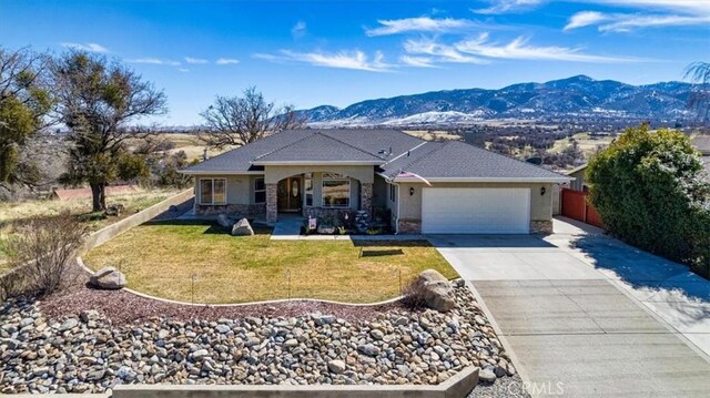22104 Mccarthy Dr, Tehachapi, CA 93561 - view of front of house with stucco siding, a garage, concrete driveway, and a mountain view