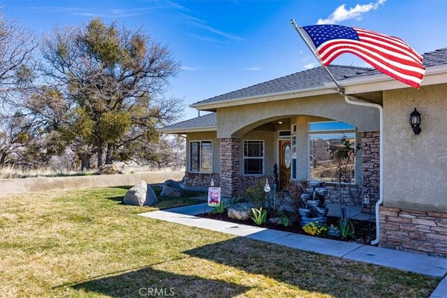 22104 Mccarthy Dr, Tehachapi, CA 93561 - view of home's exterior with stucco siding, stone siding, and a yard