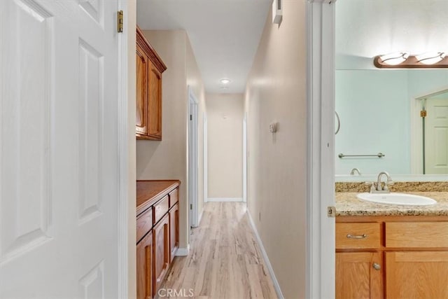 22104 Mccarthy Dr, Tehachapi, CA 93561 - bathroom with vanity, wood finished floors, and baseboards