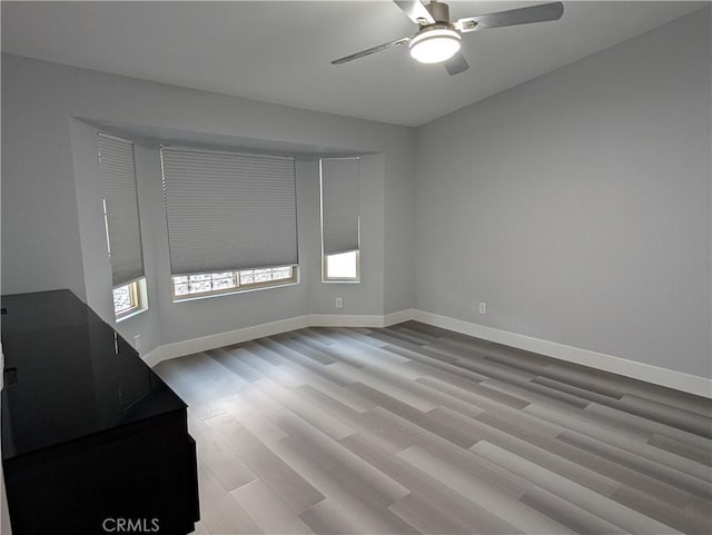 23040 Giant Fir Pl, Canyon Lake, CA 92587 - unfurnished room with wood finished floors, a ceiling fan, and baseboards