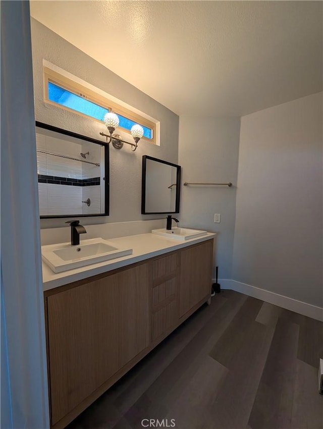 23040 Giant Fir Pl, Canyon Lake, CA 92587 - full bath with wood finished floors, double vanity, a textured ceiling, baseboards, and a textured wall