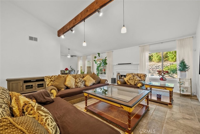 13247 Mission Tierra Way, Granada Hills, CA 91344 - living room with high vaulted ceiling, track lighting, beam ceiling, a fireplace, and light stone finish floors
