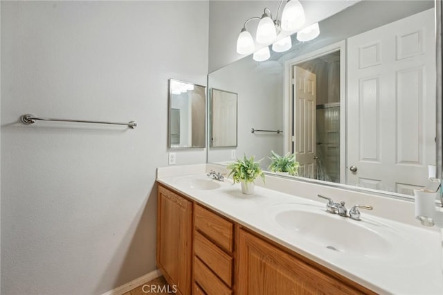 10237 Cotoneaster St, Apple Valley, CA 92308 - bathroom featuring double vanity, baseboards, and a shower