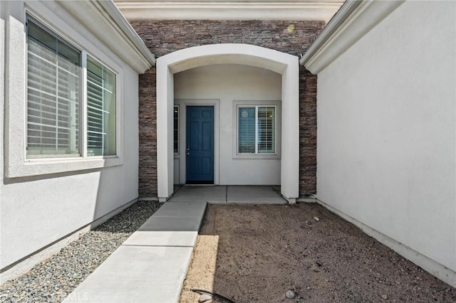 10237 Cotoneaster St, Apple Valley, CA 92308 - view of exterior entry featuring stone siding and stucco siding