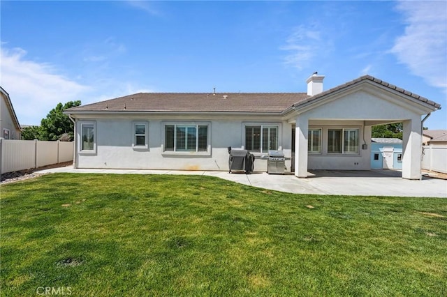 10237 Cotoneaster St, Apple Valley, CA 92308 - back of property featuring a chimney, a patio area, stucco siding, and a tile roof