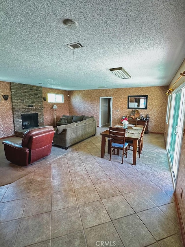 4036 N Foxdale Ave, Covina, CA 91722 - tiled living area with a textured ceiling and a fireplace