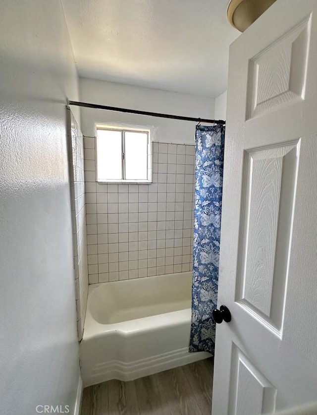 4036 N Foxdale Ave, Covina, CA 91722 - bathroom with wood finished floors and shower / bath combo with shower curtain