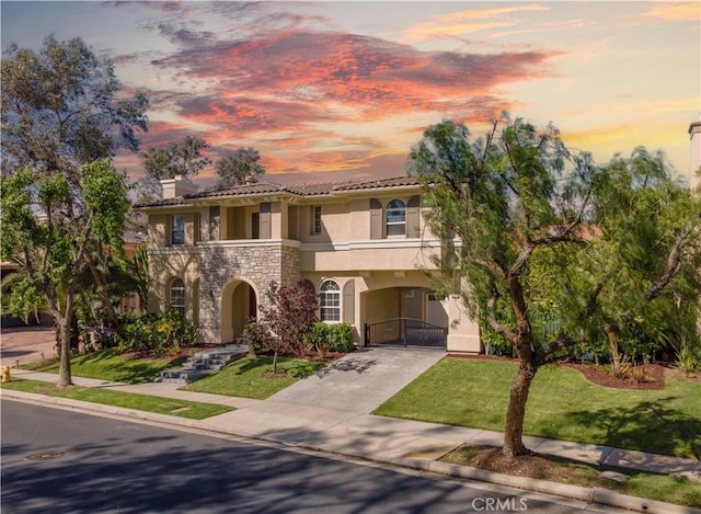 583 Ruth Cir, Corona, CA 92879 - mediterranean / spanish house featuring stucco siding, a gate, concrete driveway, stone siding, and a carport