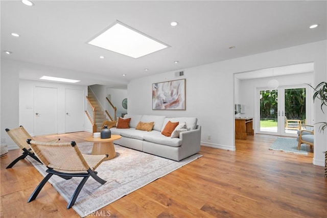 2704 Albatross Dr, Costa Mesa, CA 92626 - living area with stairs, light wood-style flooring, recessed lighting, baseboards, and a skylight