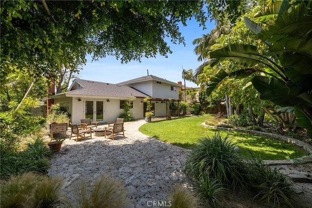 2704 Albatross Dr, Costa Mesa, CA 92626 - back of property featuring french doors, stucco siding, a patio, and an outdoor hangout area
