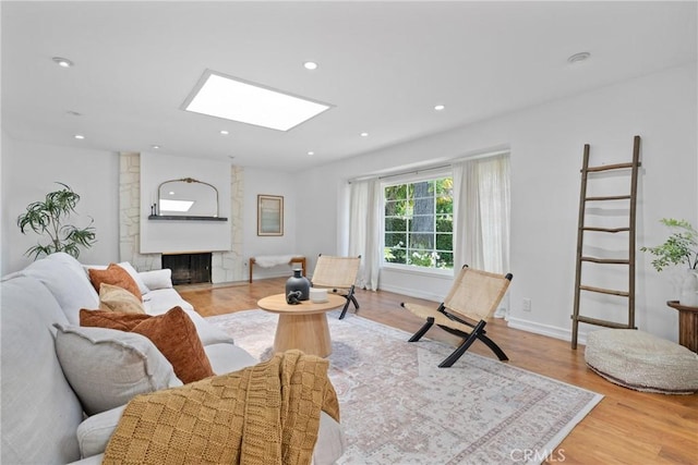 2704 Albatross Dr, Costa Mesa, CA 92626 - living area with a skylight, light wood-style flooring, a fireplace, recessed lighting, and baseboards
