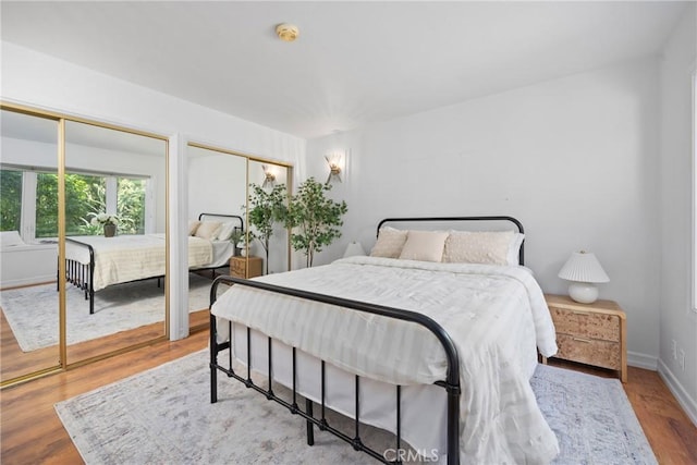 2704 Albatross Dr, Costa Mesa, CA 92626 - bedroom featuring two closets, wood finished floors, and baseboards