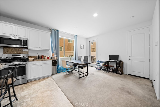5874 Silver Oaks Dr, Chino, CA 91710 - kitchen with appliances with stainless steel finishes, white cabinets, recessed lighting, and stone countertops