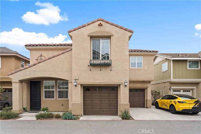 5874 Silver Oaks Dr, Chino, CA 91710 - view of front facade featuring a tiled roof, an attached garage, stucco siding, and driveway