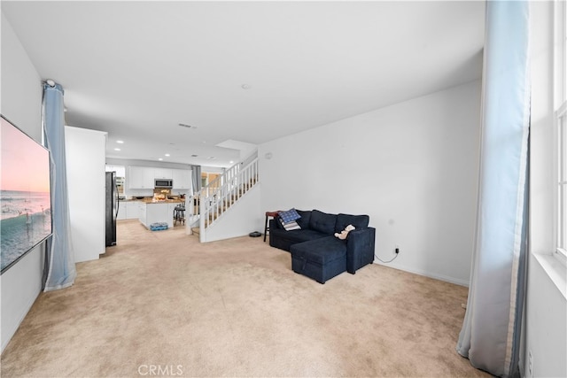 5874 Silver Oaks Dr, Chino, CA 91710 - sitting room featuring light colored carpet, stairway, and recessed lighting