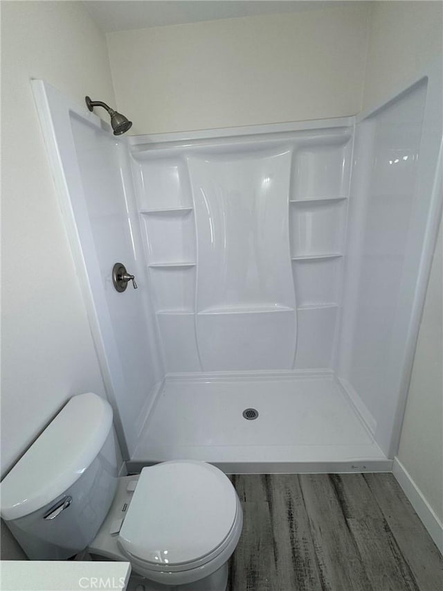 37146 Lombardy Ave, Barstow, CA 92311 - full bath with wood finished floors, toilet, a stall shower, and baseboards