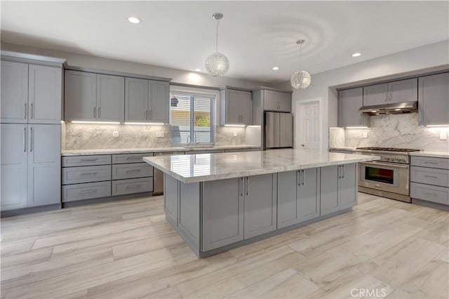 26242 Via Corrizo, San Juan Capistrano, CA 92675 - kitchen with gray cabinets, appliances with stainless steel finishes, under cabinet range hood, a kitchen island, and backsplash