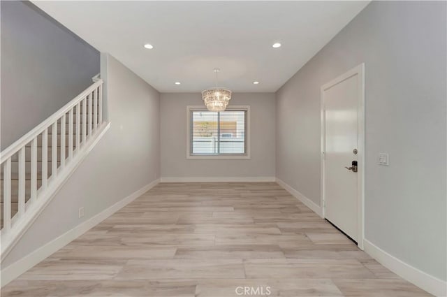 26242 Via Corrizo, San Juan Capistrano, CA 92675 - unfurnished dining area with stairway, a chandelier, light wood finished floors, recessed lighting, and baseboards