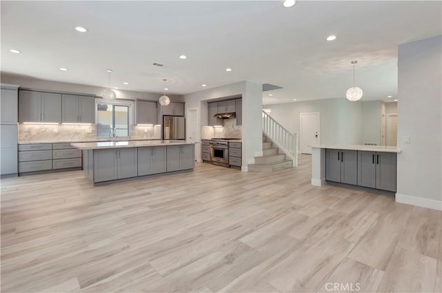 26242 Via Corrizo, San Juan Capistrano, CA 92675 - kitchen with appliances with stainless steel finishes, gray cabinetry, recessed lighting, backsplash, and light countertops