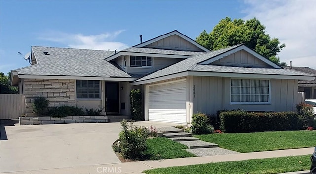 3441 Lilly Ave, Long Beach, CA 90808 - view of front of property with concrete driveway, a garage, board and batten siding, roof with shingles, and stone siding