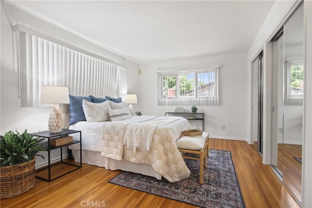 3441 Lilly Ave, Long Beach, CA 90808 - bedroom featuring multiple windows, wood finished floors, and baseboards