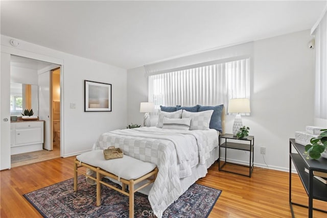 3441 Lilly Ave, Long Beach, CA 90808 - bedroom featuring multiple windows, light wood-style flooring, and baseboards