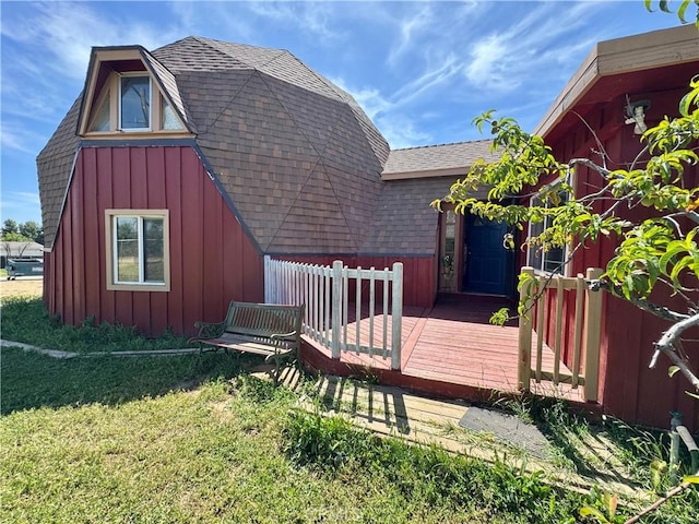 10265 Nancy Ave, Cherry Valley, CA 92223 - rear view of house with board and batten siding, a deck, roof with shingles, and a yard