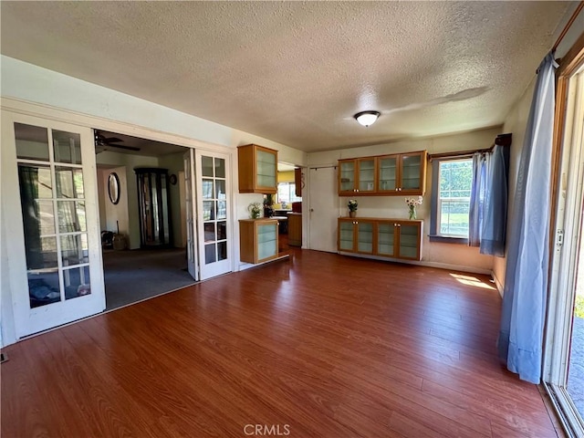 10265 Nancy Ave, Cherry Valley, CA 92223 - unfurnished living room with a textured ceiling, dark wood-style flooring, plenty of natural light, and ceiling fan