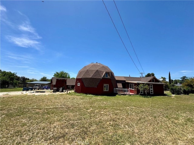 10265 Nancy Ave, Cherry Valley, CA 92223 - back of house with a lawn, a gambrel roof, a barn, and roof with shingles