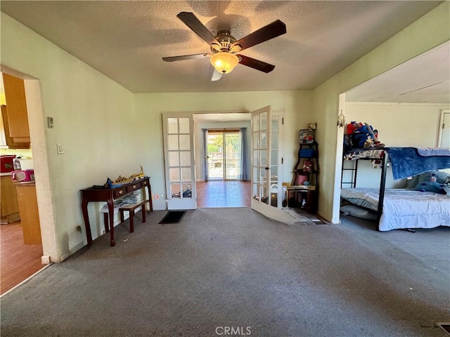 10265 Nancy Ave, Cherry Valley, CA 92223 - entrance foyer with french doors, carpet flooring, ceiling fan, and a textured ceiling